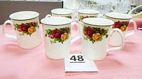 Six Royal Albert Old Country Roses bone china mugs arranged showing the floral pattern and shape.