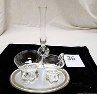 Clear glass creamer and sugar set with bubble swirl feet on oval pewter tray, alongside petal elephant foot bud vase