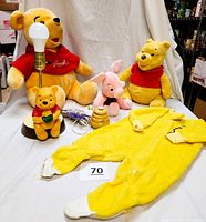 Group photo of the entire collection showing large Pooh plush, smaller Pooh plush, Piglet plush, honey pot lamp figure, ceramic honey pot, and baby sleeper