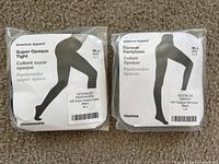 Two pairs of American Apparel pantyhose in original packaging, showing product labels and model images.