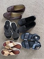 Top-down view of 5 pairs of women's shoes showing all styles in the lot.