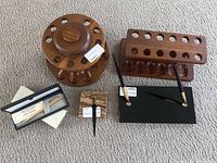 Full lot view showing wooden pipe holders, golf pen in box, marble pen stand with 2 pens, and two marble pen holders.