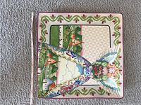 Front view of the 13x13 inch ceramic square platter with colorful angel design and farm scenery.