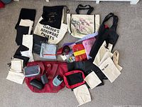 Overview of all miscellaneous bags, totes, pouches, and accessories included in the lot