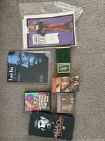 Overview of lot showing sheet music, DVD, CD, VHS tapes, and pin pack