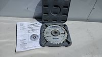 Open view of the 8 inch carbide tipped dado blade inside its plastic case with instruction manual.