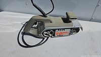 Black & Decker belt sander showing full length of tool and handle.