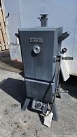 Full view of the Master Forge propane smoker showing its front, temperature gauge, and control knob.