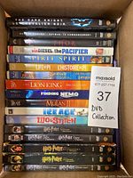 Photo showing vertically stacked DVD cases including The Dark Knight, Thor, The Pacifier, Spirit, Life of Pi, Sinbad, The Lion King, Finding Nemo, Mulan II, Ice Age, Lilo & Stitch, 3 Harry Potter movies.