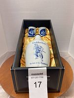Full view of the boxed sake bottle decanter and two cups, highlighting the samurai design and brand name lettering