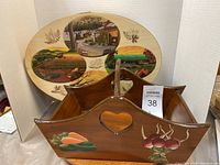 Photo showing rectangular wooden caddy with a heart-shaped cutout handle and painted carrots and onions.