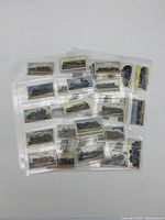 Overview of 36 vintage Wills's tobacciana train collectible cards in plastic sleeves, showing various train illustrations.