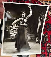 Photo showing vintage black and white 8x10 stage photo of Claudette dancing in long skirt and halter top