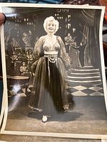 Single black and white 8 x 10 photo of Runa Rae in burlesque costume with stage backdrop marked 'Savoy'