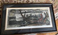 Full view of the framed abstract art featuring Viking boats with a wall and river in the background.