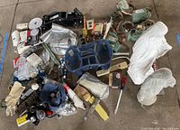 Overview of lot showing garden statues, lighting fixtures, hand tools, hydraulic jack, gloves, and other assorted items.