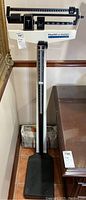 Full view of vintage Health-o-meter professional doctor's scale standing upright with height rod and weighing platform, showing overall condition and size.