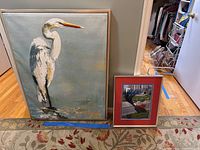 Wide shot showing both artworks side by side on floor with wooden floor and patterned rug underneath