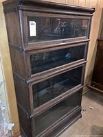 Front view showing four stacking glass-front compartments