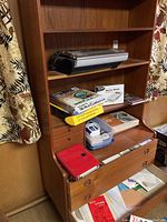 Front view showing three adjustable shelves, three small drawers at top and three large drawers at bottom with items in place