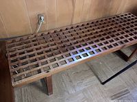 Full bench side view against paneled wall