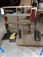 Overview of the entire lot showing wooden shelf, metal box with computer mice, and large wooden wool spinning component parts.