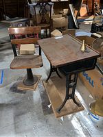 Photo showing the vintage school desk and matching swivel chair, highlighting the metal frame and wooden surfaces along with the ink well on the desk.
