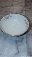 White porcelain bowl shown from top view to display inner surface and floral design