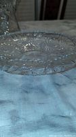 Side view of a clear crystal fruit bowl highlighting star and geometric cut patterns on the rim and body.