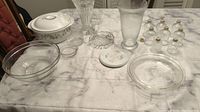 Wide photo of all items including covered casserole dish, crystal vase, pie plates, small glass containers, and other miscellaneous glassware.