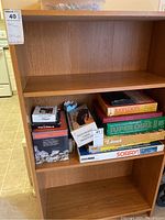 Front view of the MDF board bookcase shelving unit containing board games and boxed items (not included).