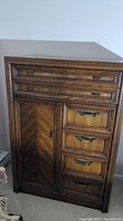 Front view of the wooden dresser showing overall condition, drawer fronts, door and hardware.