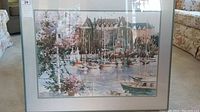 Full view of framed watercolor painting showing harbor with boats and large building labeled 'Empress'