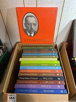 Photo of a cardboard box with multiple Time Life vinyl record box sets stacked neatly, showing colorful spines with composer names and series title 'Great Men of Music'.