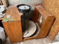 Side view of pottery wheel and wooden bench assembly