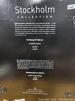 Photo of black product box with Stockholm Collection branding, details on Scandinavian design inspiration and mirror specifications 21" available in black and white.