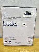 Back of packaging showing Kode brand name, product information, and certification details for a set of 2 king pillowcases.