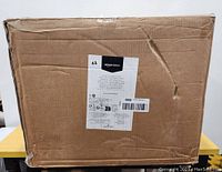 Boxed Amazon Basics cat tree tower. Box shows labels and product information.