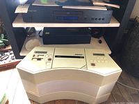 Overview of Cambridge Audio Topaz CD10 on top shelf and Bose CD player on bottom shelf showing overall condition and size difference