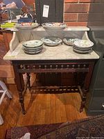 Front view showing marble surface and gallery back