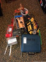 Full overview of tools including Bosch jigsaw case, DeWalt grinder bag, wood clamps, and tap and die set.