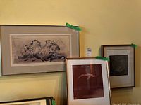 All three framed pieces displayed together on wall
