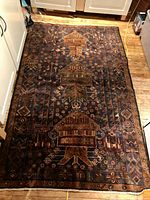 Full view of rug laid on wood floor showing overall pattern and dimensions