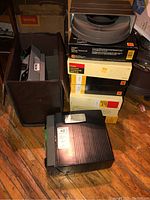 Two Kodak slide projectors and several boxes of empty carousel trays stacked on the floor