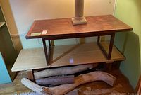 Full view of console table on display with lower shelf and wood branches beneath (branches not included)