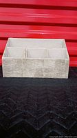 Front view of desk caddy showing five compartments and faux snakeskin texture in grey/beige.