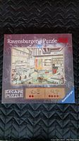 Front view of Ravensburger Escape Puzzle box showing the 368 piece count and image of puzzle depicting a room interior scene