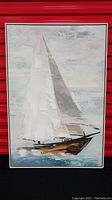 Full view of framed sailboat artwork with cloudy sky and water background.