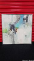 Full view of square abstract art in floating frame showing the overall composition and colors predominantly white, blue, black, green.