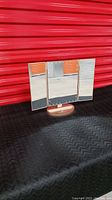 Vanity mirror closed with side panels visible on red background